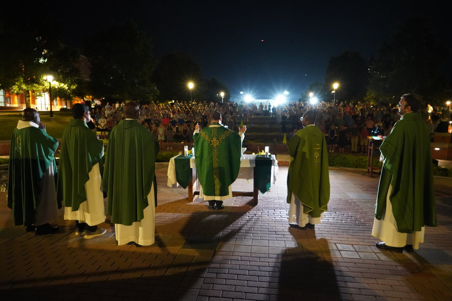 Father Paul Clark and concelebrating priests gather around the altar for the Consecration during this year’s Mass in the Quad on the campus of the University of Missouri in Columbia.